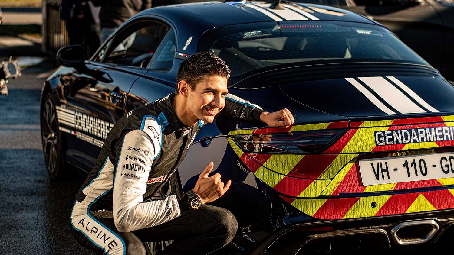 Esteban Ocon with an Alpine French police car.v1